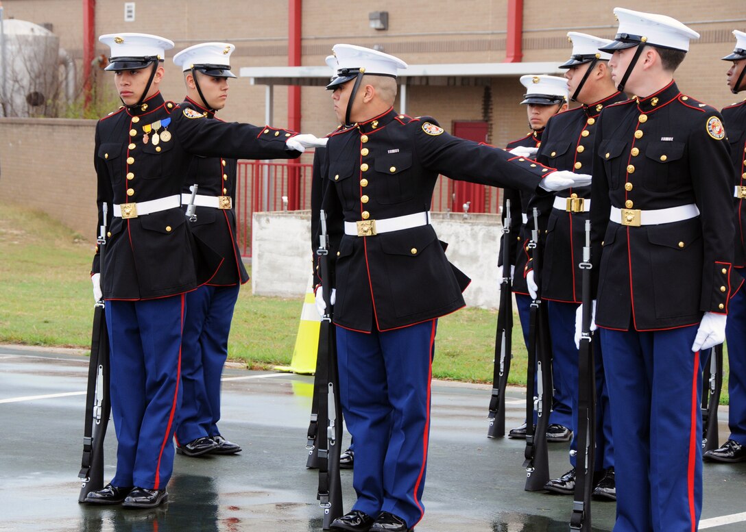 Marine Corps Junior Reserve Officer Training Corps cadets from W.T. White High School adjust their formation for an inspection prior to competing in the armed drill event at an all-Marine JROTC competition at Jack C. Hays High School, in Buda, Texas, March 5, 2011.